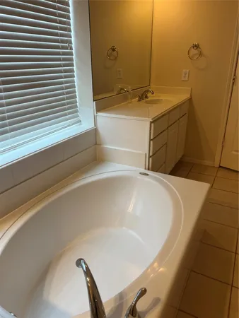 a bathroom with a bathtub and sink