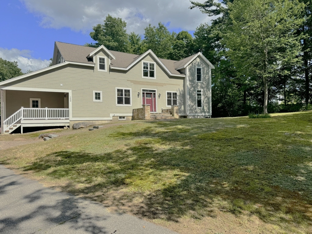 150 Packard Hill Road Ashburnham, MA 01430 - Photo 1 of 31 a front view of a house with a yard