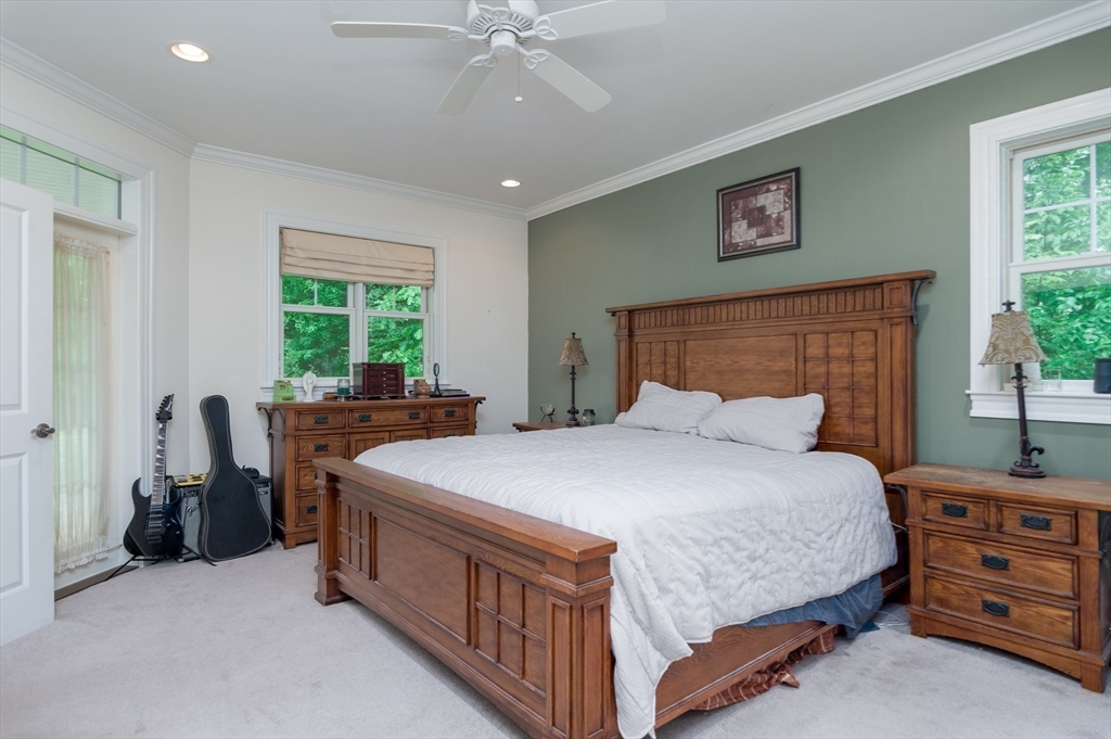 150 Packard Hill Road Ashburnham, MA 01430 - Photo 12 of 31 a bed room with a bed and a chandelier