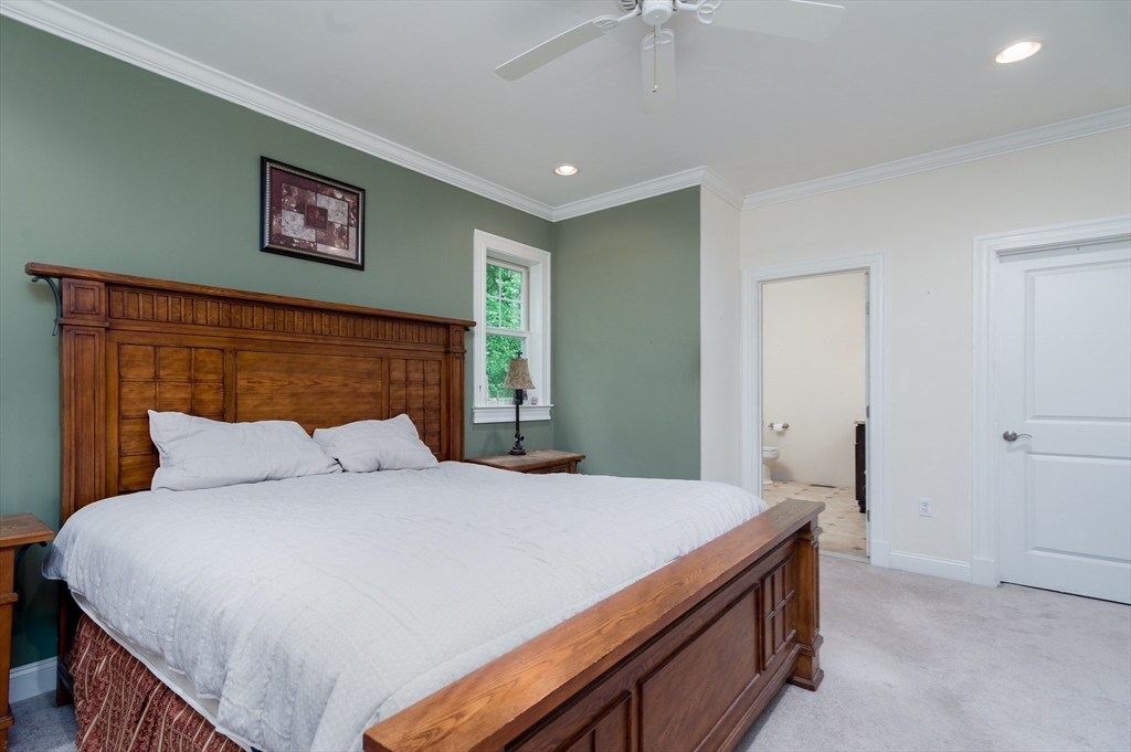 150 Packard Hill Road Ashburnham, MA 01430 - Photo 13 of 31 a bedroom with a large bed and a chandelier