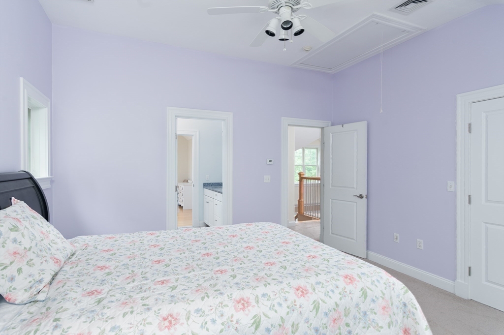 150 Packard Hill Road Ashburnham, MA 01430 - Photo 27 of 31 a bedroom with a bed and a chandelier