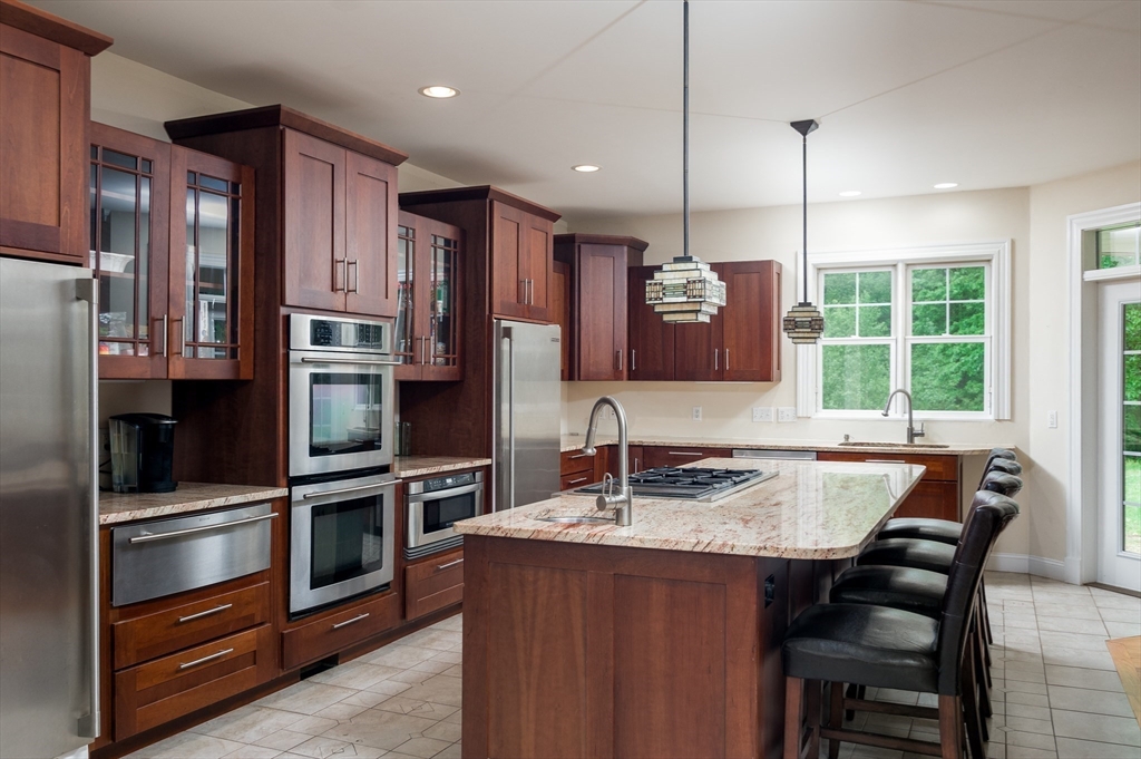 150 Packard Hill Road Ashburnham, MA 01430 - Photo 3 of 31 a kitchen with stainless steel appliances granite countertop a stove refrigerator and cabinets