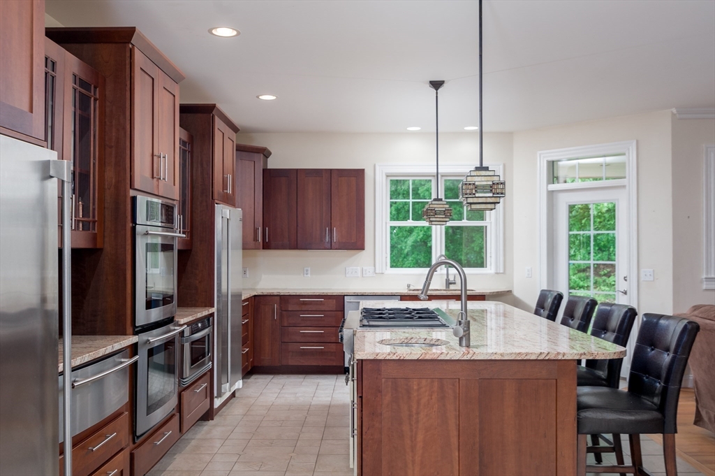 150 Packard Hill Road Ashburnham, MA 01430 - Photo 5 of 31 a kitchen with kitchen island granite countertop a sink appliances and cabinets