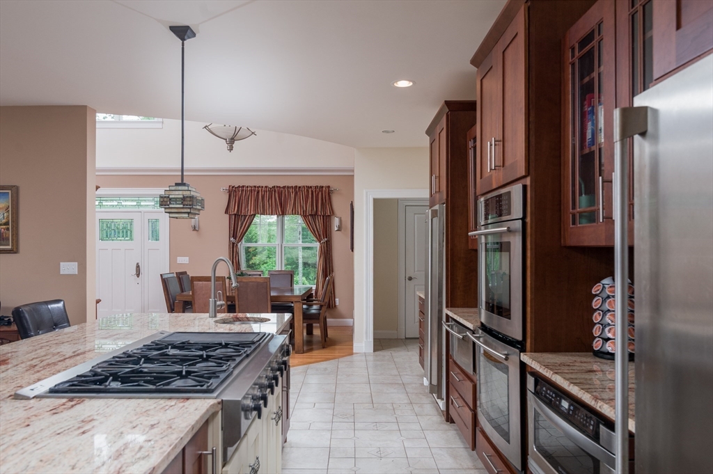150 Packard Hill Road Ashburnham, MA 01430 - Photo 6 of 31 a kitchen with stainless steel appliances granite countertop a stove a refrigerator and a wooden cabinets