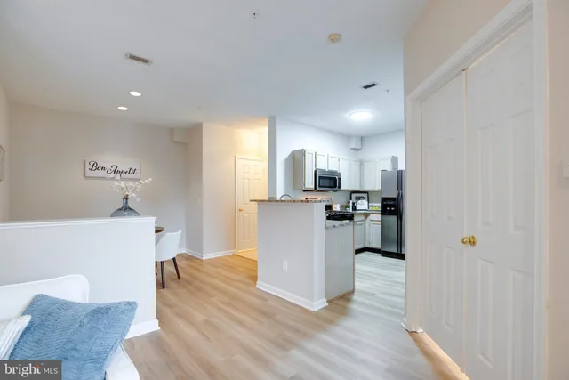 a kitchen with a refrigerator and a sink