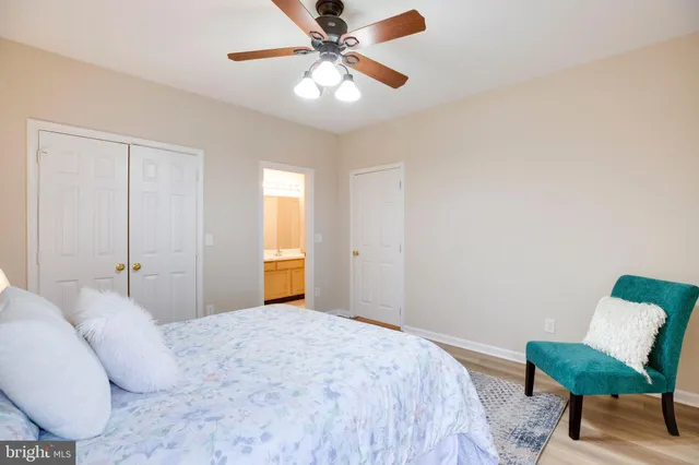 a bedroom with a bed and a chair