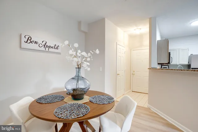 a view of a dining room with furniture wooden floor and a chandelier