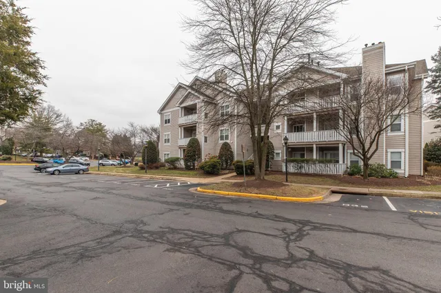 a front view of a building with trees