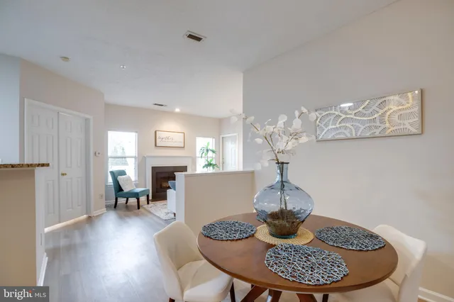 a dining room with furniture a rug and wooden floor