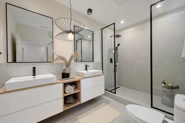 a bathroom with a sink a toilet and shower