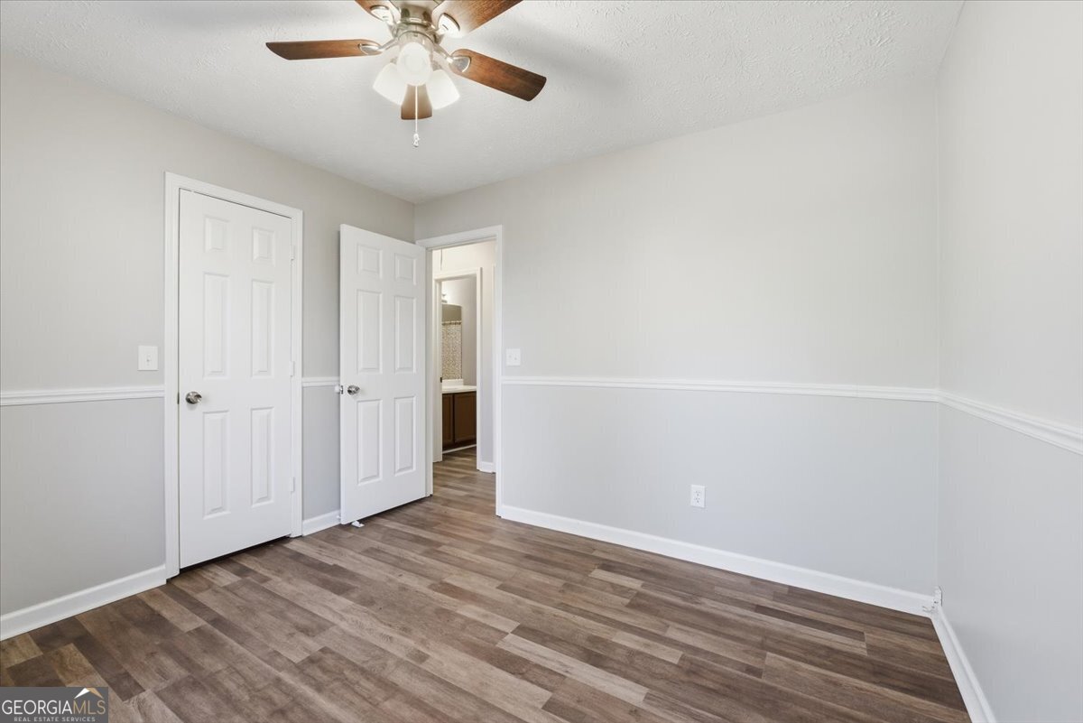 93 Robin Hood Road Covington, GA 30014 - Photo 14 of 20 a view of an empty room with wooden floor