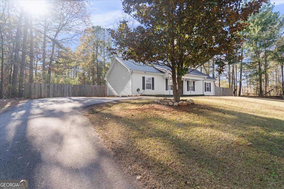 93 Robin Hood Road Covington, GA 30014 - Photo 2 of 20 a front view of a house with a yard and trees