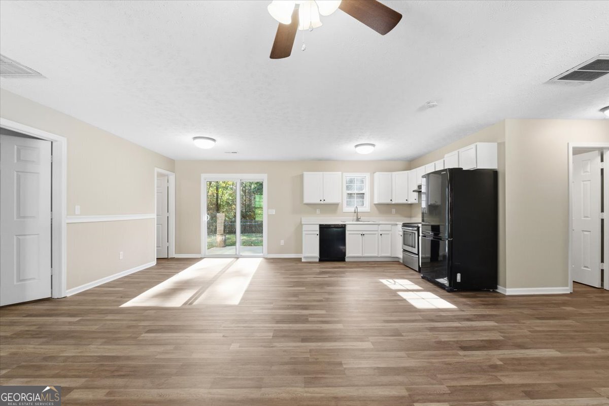 93 Robin Hood Road Covington, GA 30014 - Photo 4 of 20 a view of a kitchen with refrigerator and window
