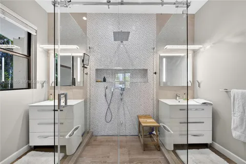 a bathroom with a double vanity sink mirror and toilet