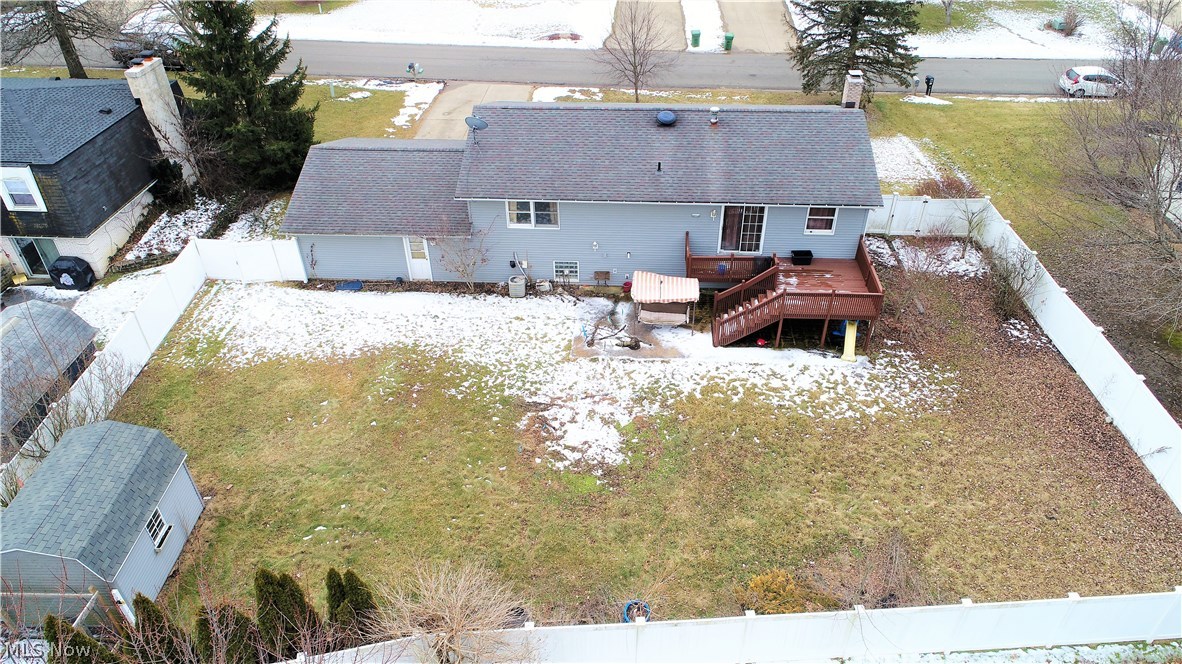 1560 Reed Street Canal Fulton, OH 44614 - Photo 6 of 7 Aerial view of the spacious fenced backyard with deck, patio and large storage shed.