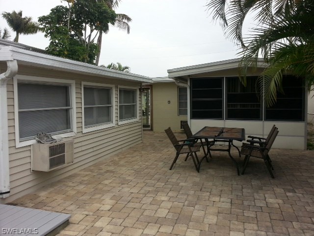 2606 Second Street Cape Coral, FL 33993 - Photo 15 of 24 a backyard of a house with table and chairs
