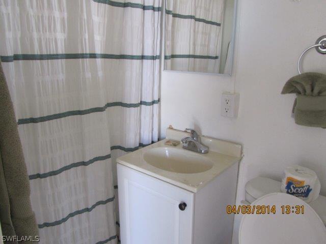2606 Second Street Cape Coral, FL 33993 - Photo 18 of 24 a bathroom with a sink and mirror