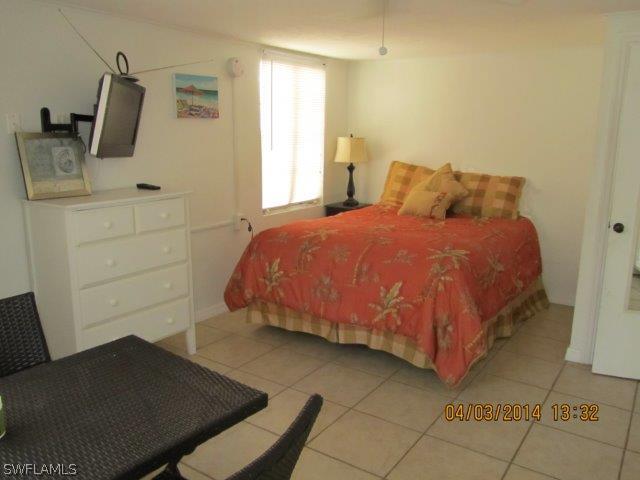 2606 Second Street Cape Coral, FL 33993 - Photo 19 of 24 a bedroom with a bed and flat screen tv