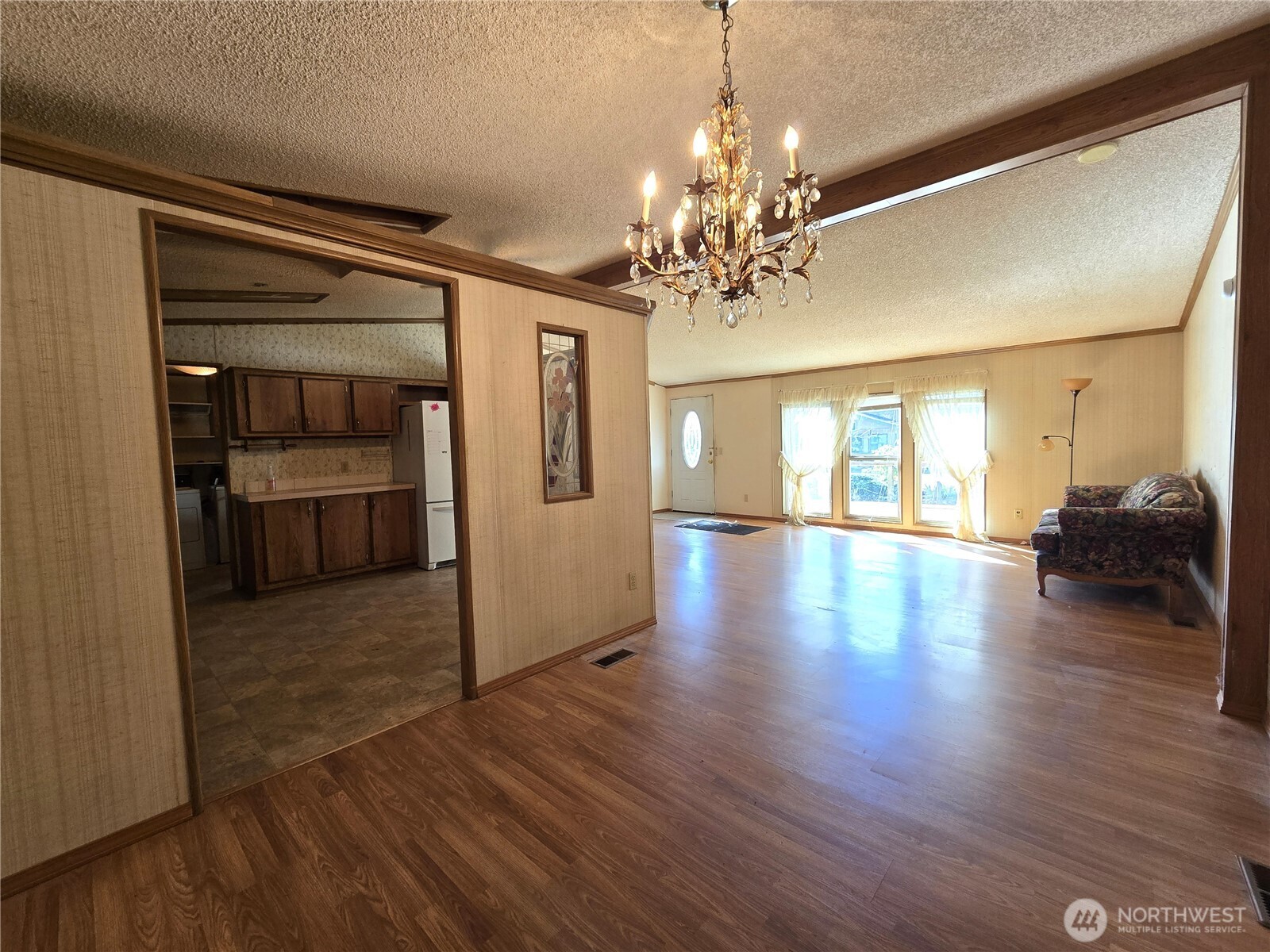 520 North 3rd Street Elma, WA 98541 - Photo 12 of 28 a view of a livingroom with wooden floor and kitchen