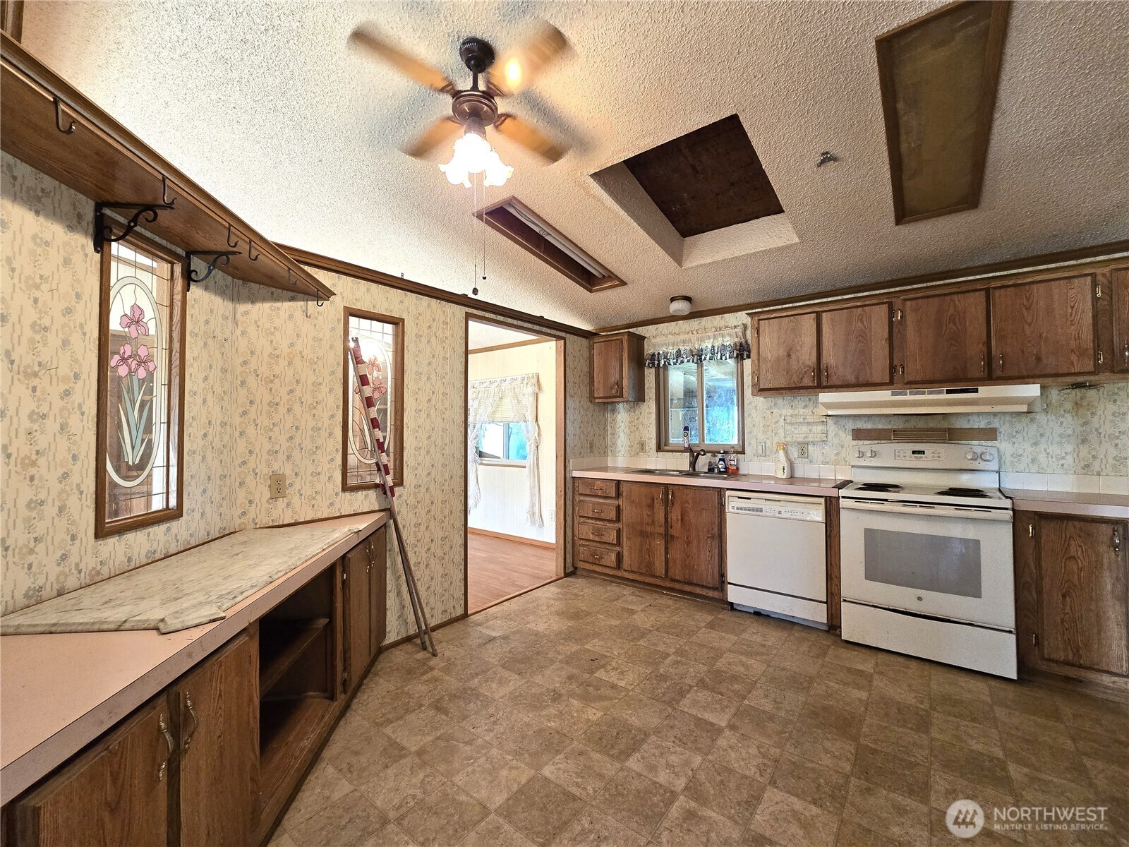 520 North 3rd Street Elma, WA 98541 - Photo 15 of 28 a kitchen with granite countertop a sink stainless steel appliances and counter space