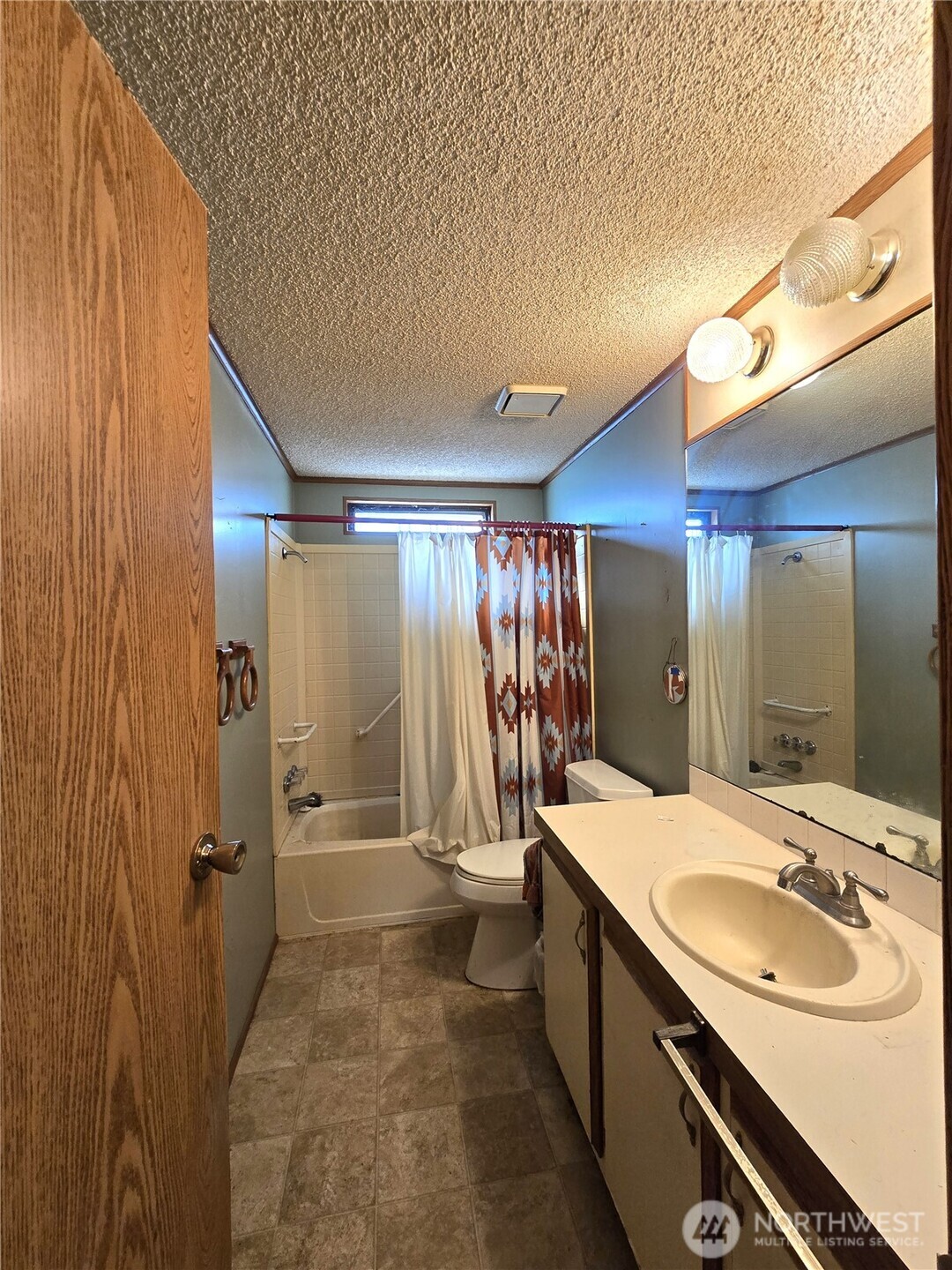 520 North 3rd Street Elma, WA 98541 - Photo 17 of 28 a bathroom with a double vanity sink and mirror with shower