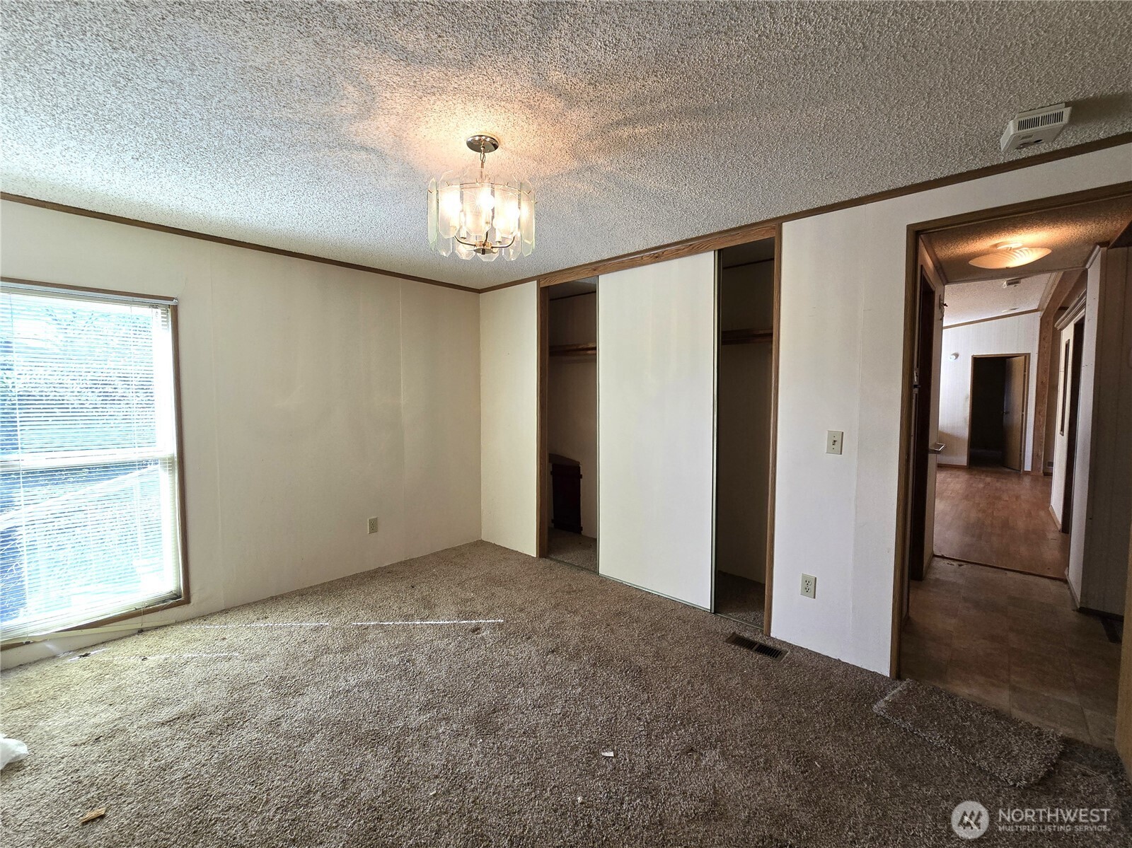 520 North 3rd Street Elma, WA 98541 - Photo 19 of 28 an empty room with chandelier fan and windows