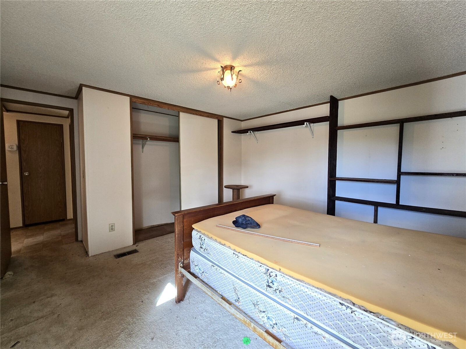 520 North 3rd Street Elma, WA 98541 - Photo 21 of 28 a bedroom with a bed and a chandelier