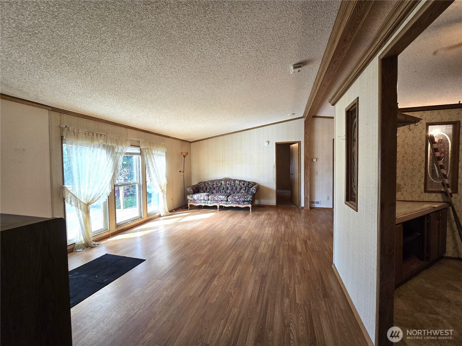 520 North 3rd Street Elma, WA 98541 - Photo 6 of 28 a hallway with wooden floor fireplace and windows