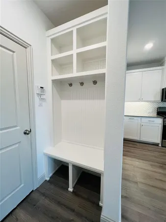 a view of kitchen with wooden floor and electronic appliances