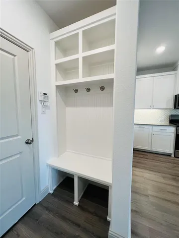 a view of kitchen with wooden floor and electronic appliances