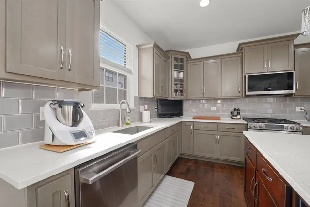 a kitchen with a sink cabinets and appliances