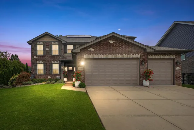 a view of a house with a yard and garage