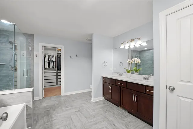 a spacious bathroom with a sink and a mirror