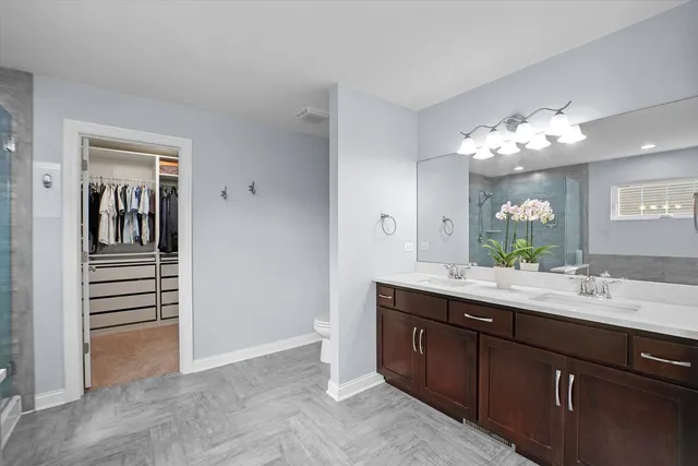a spacious bathroom with a double vanity sink and a mirror