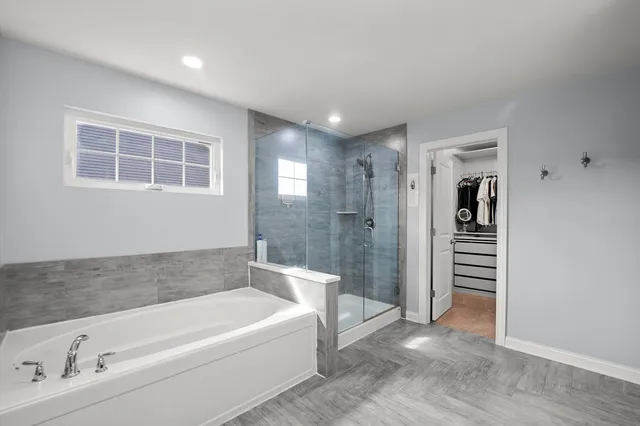 a bathroom with a bathtub and a sink