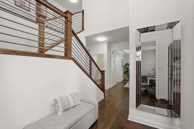a view of a hallway with wooden floor and staircase