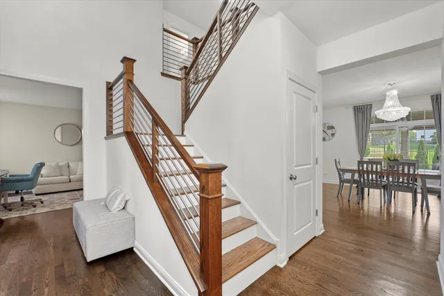 a view of entryway and hall with wooden floor