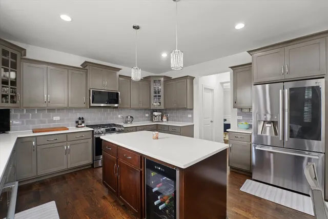 a kitchen with a sink a counter top space stainless steel appliances and cabinets