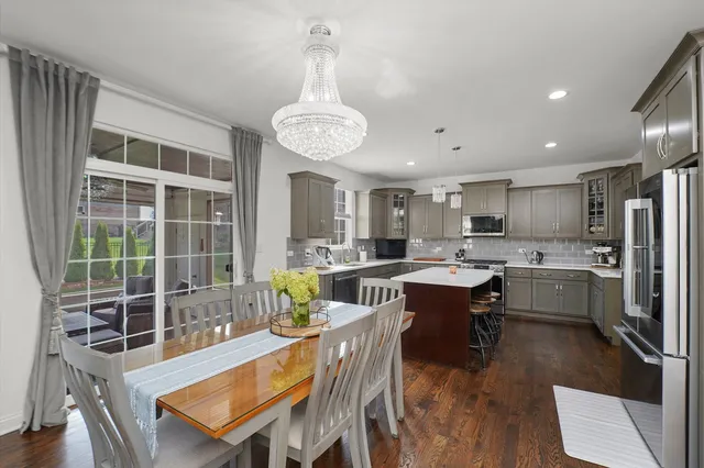 a large kitchen with a table and chairs in it