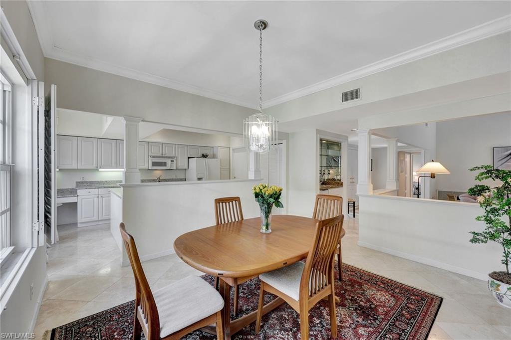 5929 Chanteclair Drive, Unit 8 Naples, FL 34108 - Photo 12 of 28 Dining area featuring light tile patterned floors, crown molding, decorative columns, and visible vents