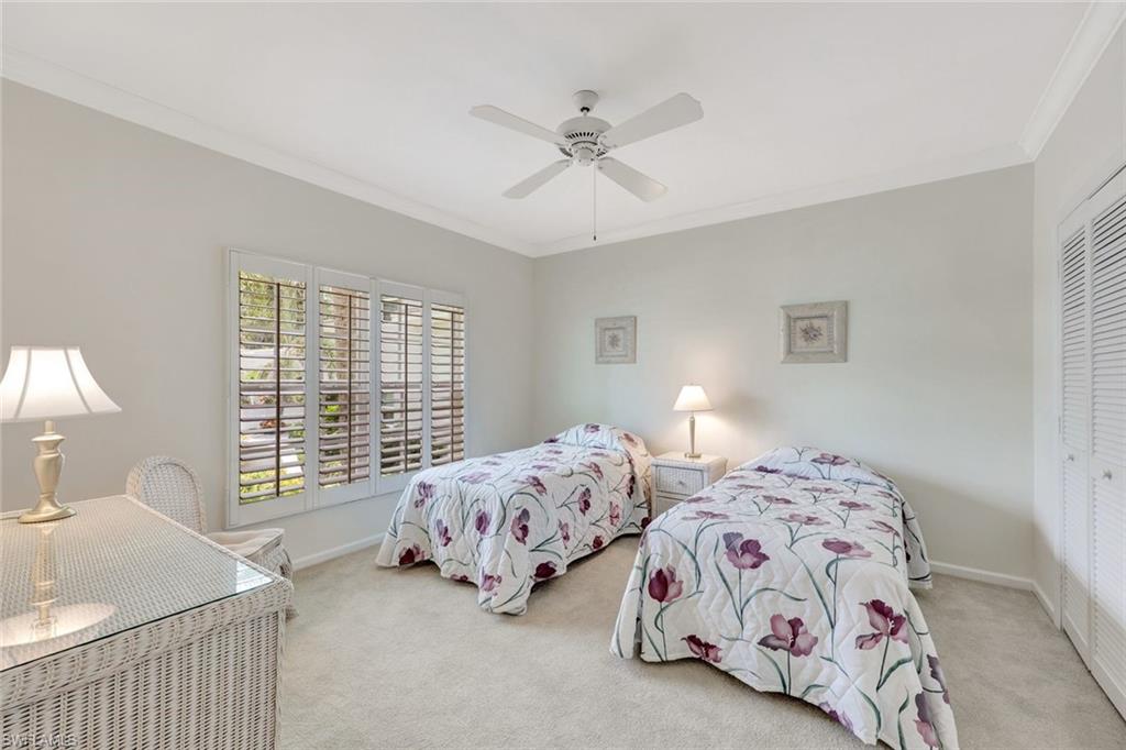 5929 Chanteclair Drive, Unit 8 Naples, FL 34108 - Photo 8 of 28 Bedroom with carpet floors, ornamental molding, baseboards, and a closet