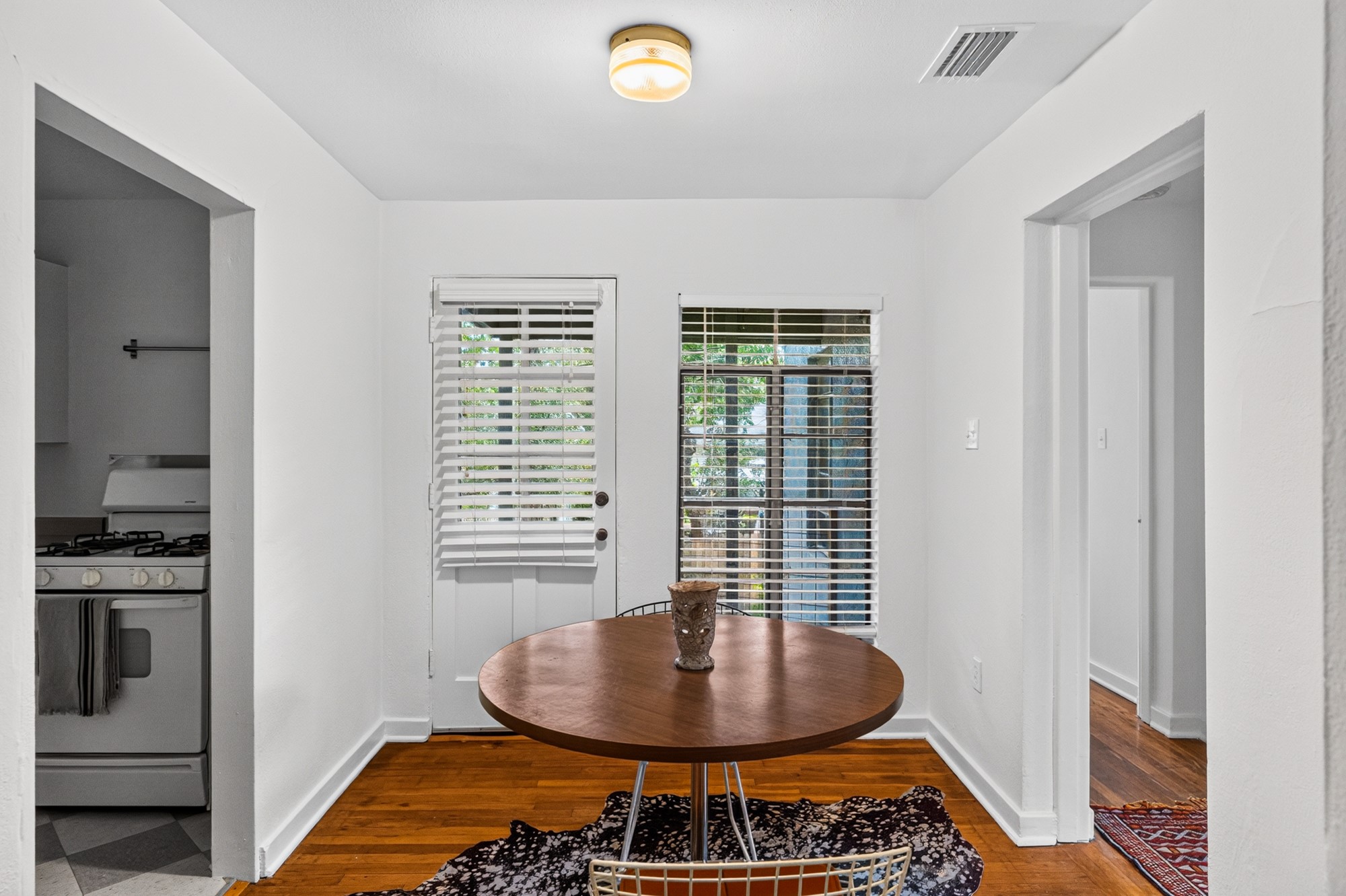 1302 Kirkwood Road, Unit B Austin, TX 78722 - Photo 5 of 21 Hardwood flooring extends throughout this versatile space, perfect for dining or an office nook.