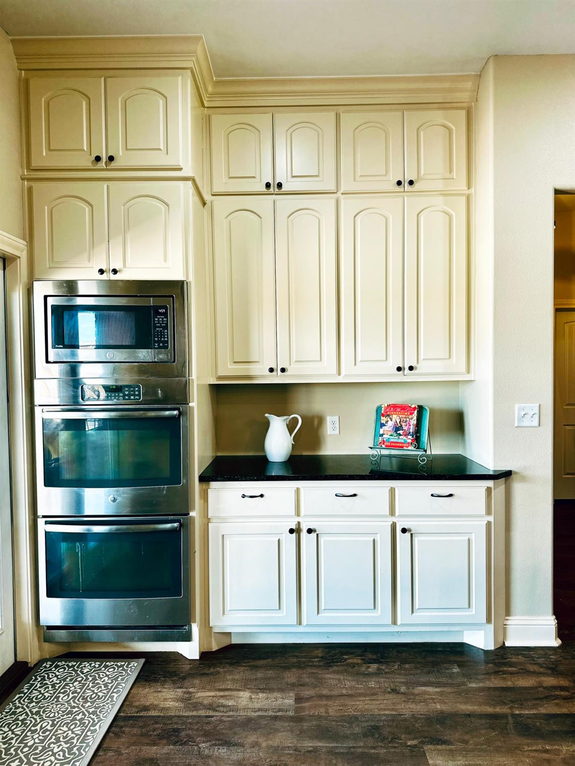 986 County Road 224 Post, TX 79356 - Photo 12 of 42 a kitchen with stainless steel appliances white cabinets and a wooden floor
