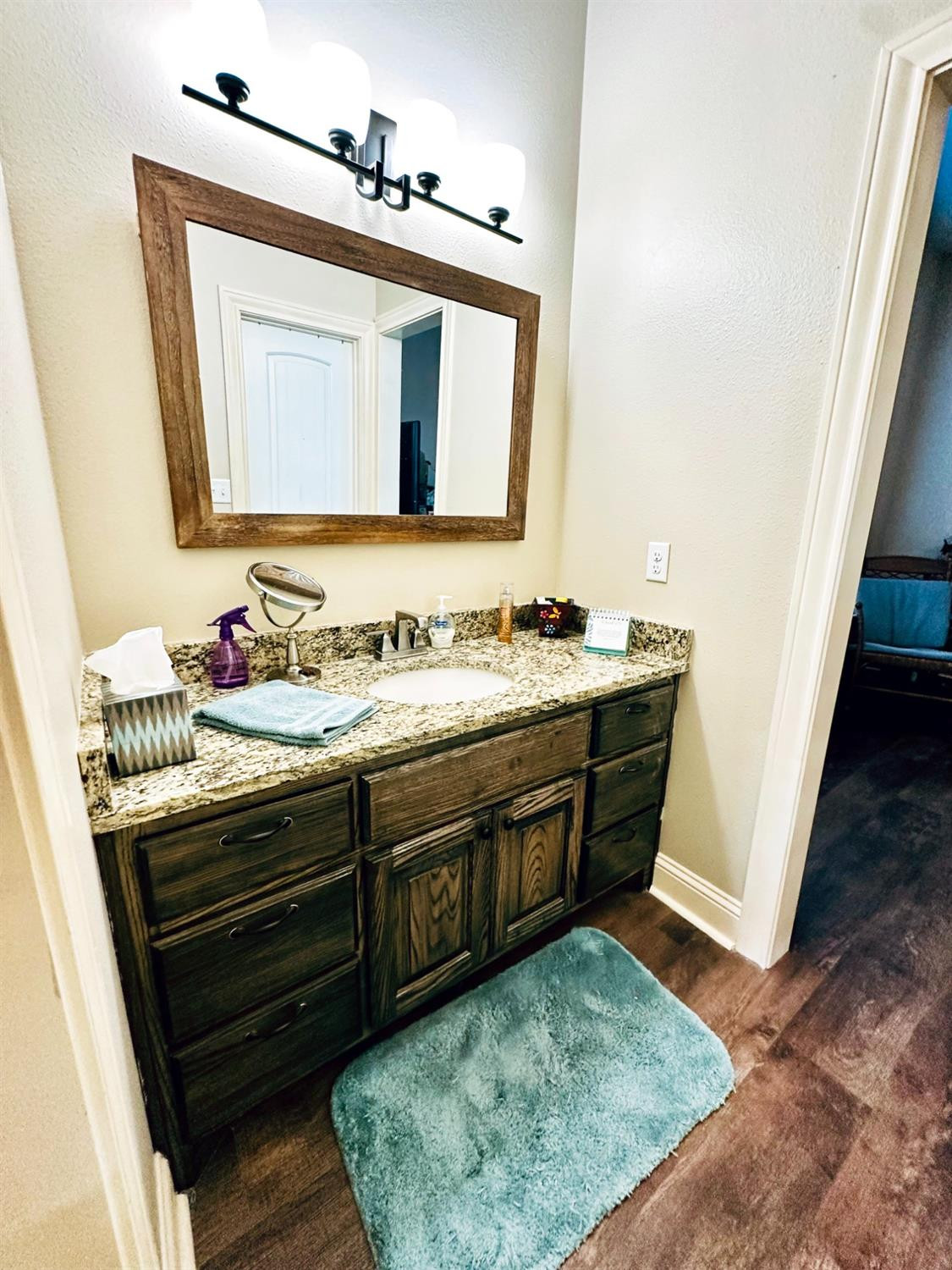 986 County Road 224 Post, TX 79356 - Photo 26 of 42 a bathroom with a granite countertop sink and a mirror