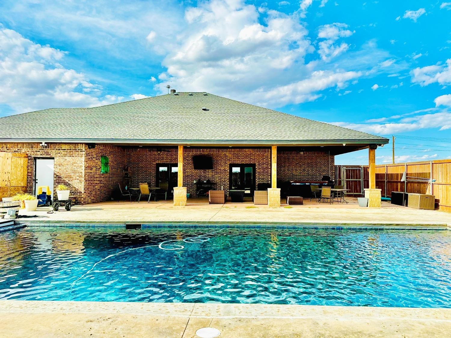 986 County Road 224 Post, TX 79356 - Photo 31 of 42 a view of a house with swimming pool and a yard