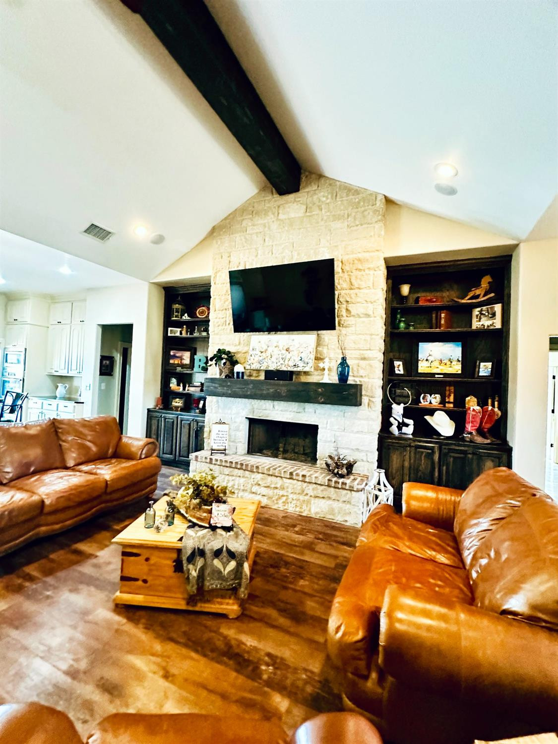 986 County Road 224 Post, TX 79356 - Photo 8 of 42 a living room with furniture a flat screen tv and a fireplace