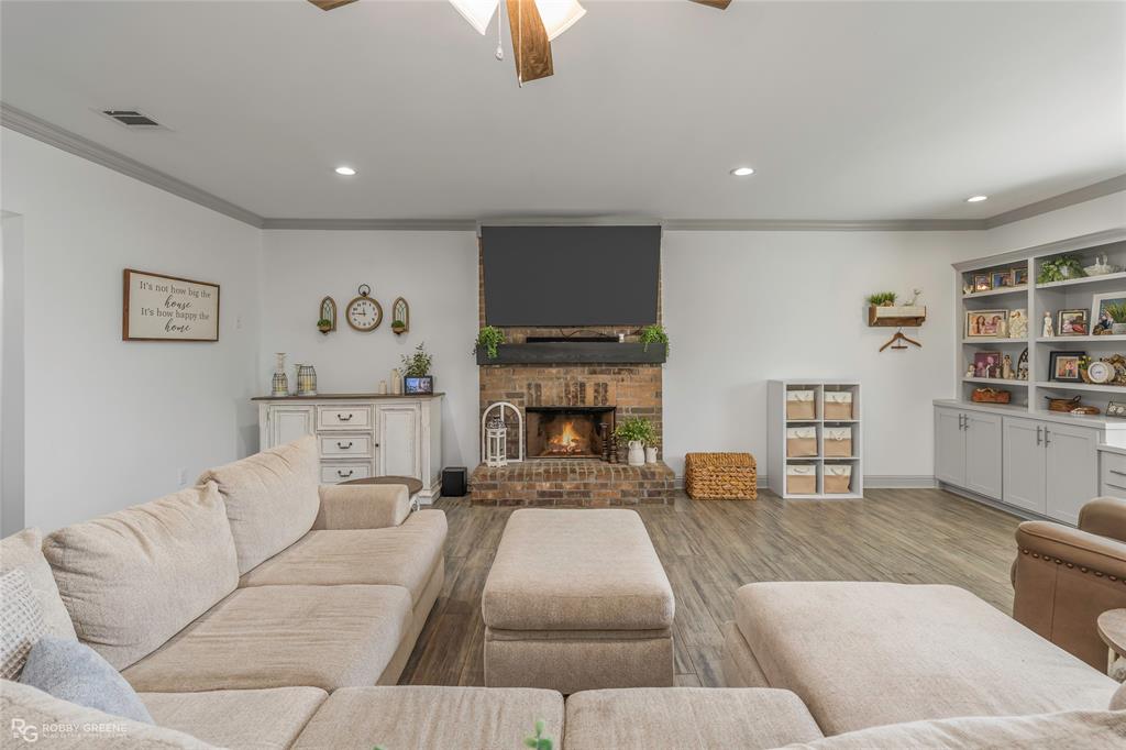 396 Collinswood Road Stonewall, LA 71078 - Photo 9 of 32 a living room with furniture and a fireplace