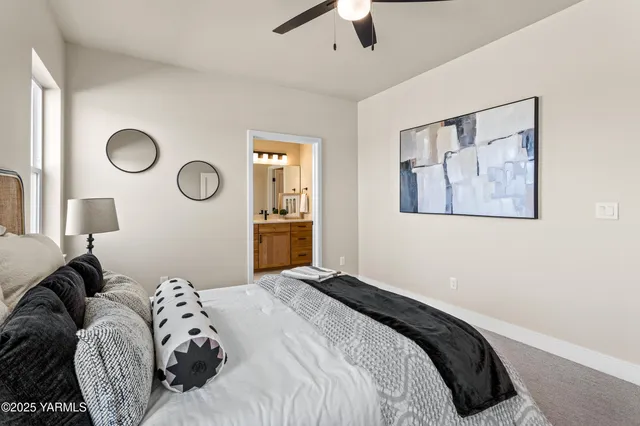 a bedroom with a bed and painting on the wall