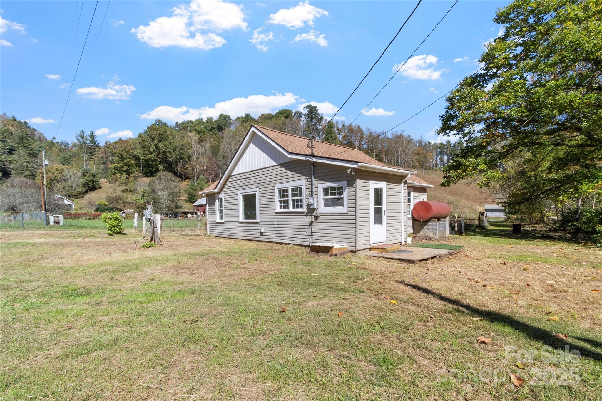 689 Bald Mountain Road Burnsville, NC 28714 - Photo 1 of 21 a front view of a house with a yard and garage