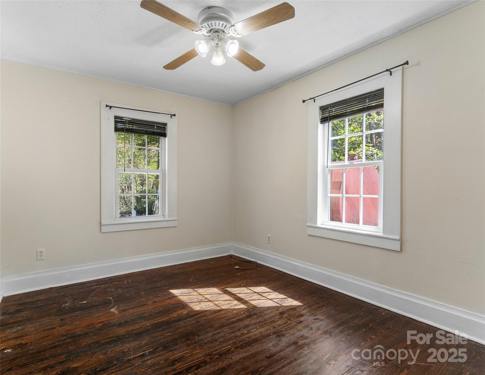 689 Bald Mountain Road Burnsville, NC 28714 - Photo 12 of 21 a view of an empty room with wooden floor and a window